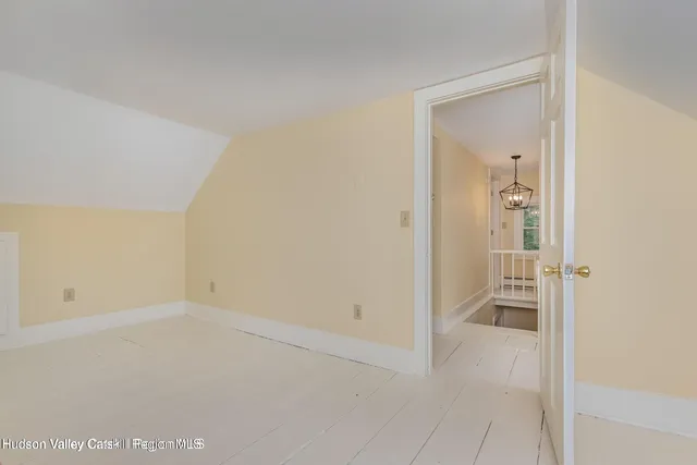 a view of a room with wooden floor and chair