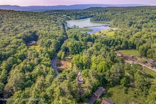 a view of a lake with a house in the background