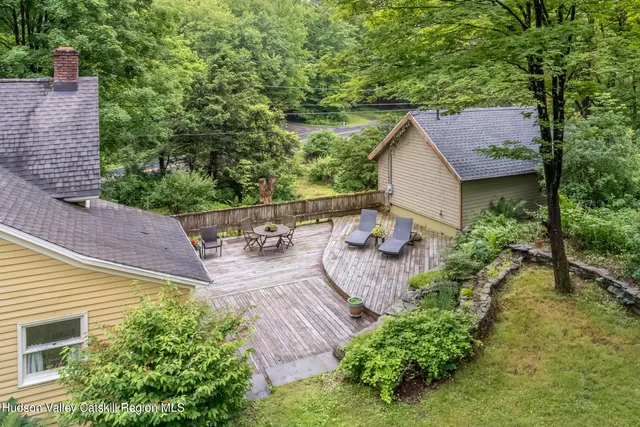 an aerial view of a house with yard and outdoor seating