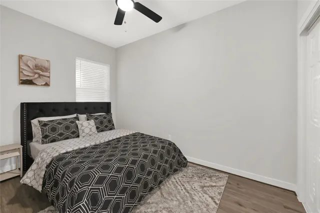 a bedroom with a bed and painting on the wall