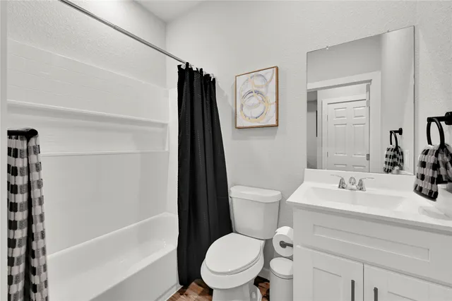 a bathroom with a sink toilet vanity and tub