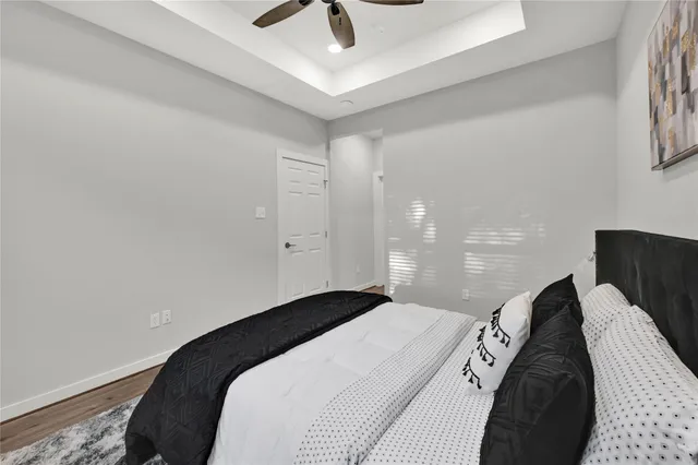 a bedroom with bed and a night stand