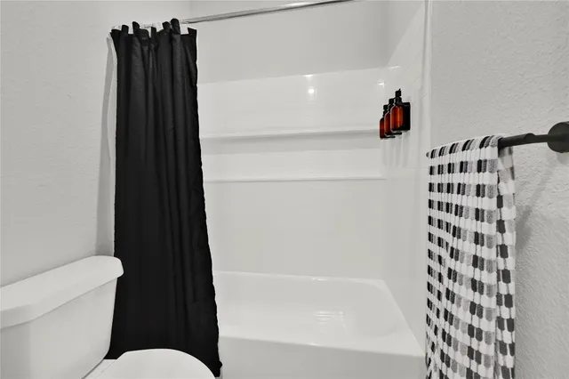 a bathroom with a bathtub and a shower