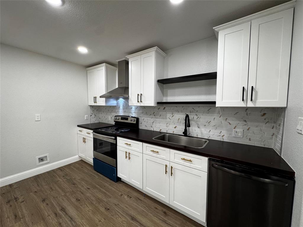 2909 Alexander Avenue Waco, TX 76708 - Photo 7 of 27 Kitchen featuring stainless steel electric range oven, dark countertops, dishwashing machine, white cabinetry, and open shelves