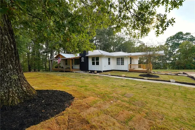 a view of a house with swimming pool and sitting area