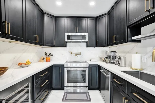 a kitchen with granite countertop a sink and cabinets