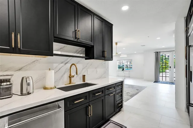 a large bed sitting in a bedroom next to a window