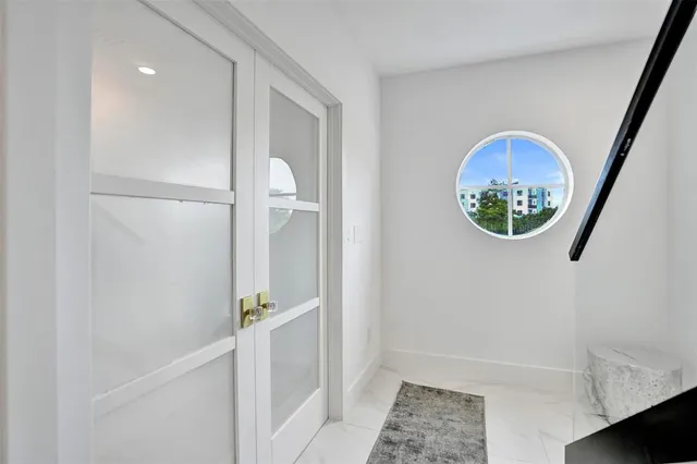 a view of a dining room with furniture and a chandelier