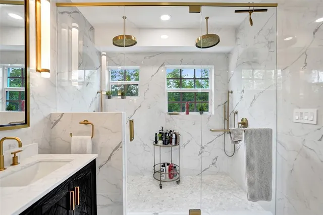 a bathroom with a double vanity sink toilet and a mirror
