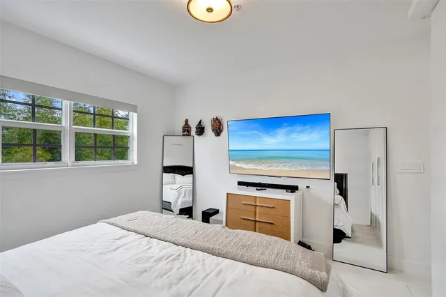 a bedroom with a bed and a lamp