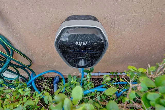 an aerial view of residential houses with outdoor space and trees