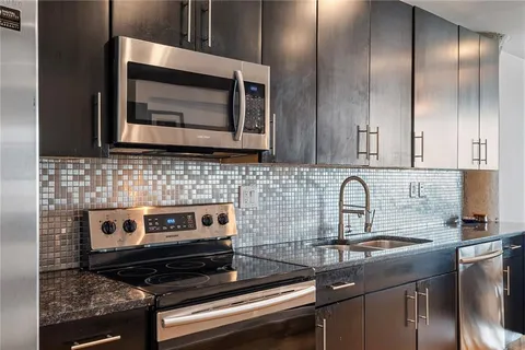 a spacious bedroom with a bed and large windows