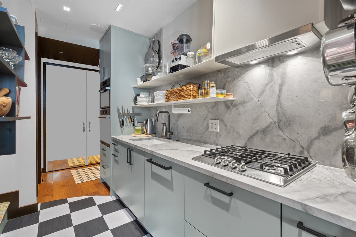 a kitchen with stainless steel appliances granite countertop a stove and a sink