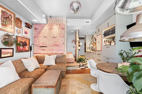 a living room with furniture flowerpot and a chandelier