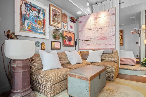 a living room with furniture and a painting