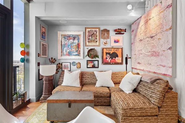 a living room with furniture and painting on the wall