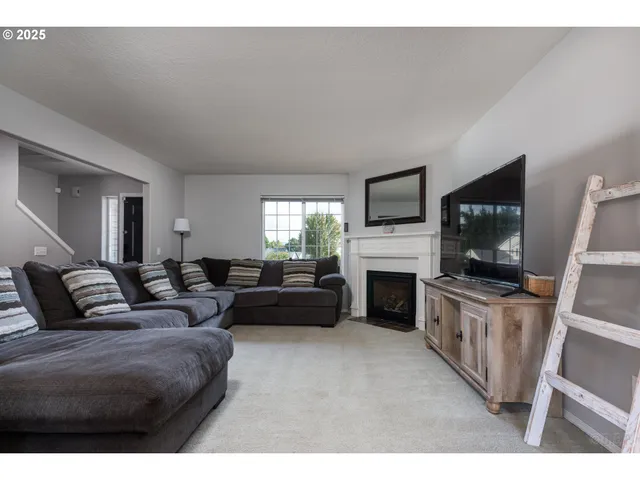 a living room with fireplace furniture and a flat screen tv