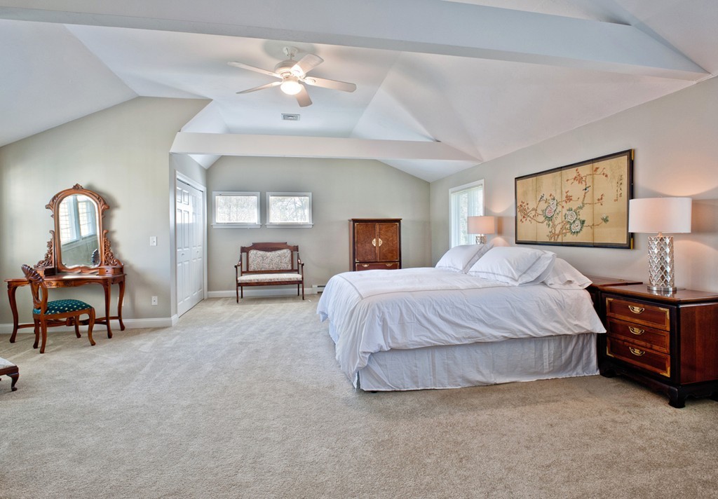 79 Linden Lane Hanover, MA 02339 - Photo 16 of 30 a spacious bedroom with a bed and a chandelier