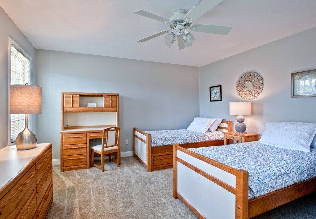 79 Linden Lane Hanover, MA 02339 - Photo 17 of 30 a bedroom with a bed and a chandelier