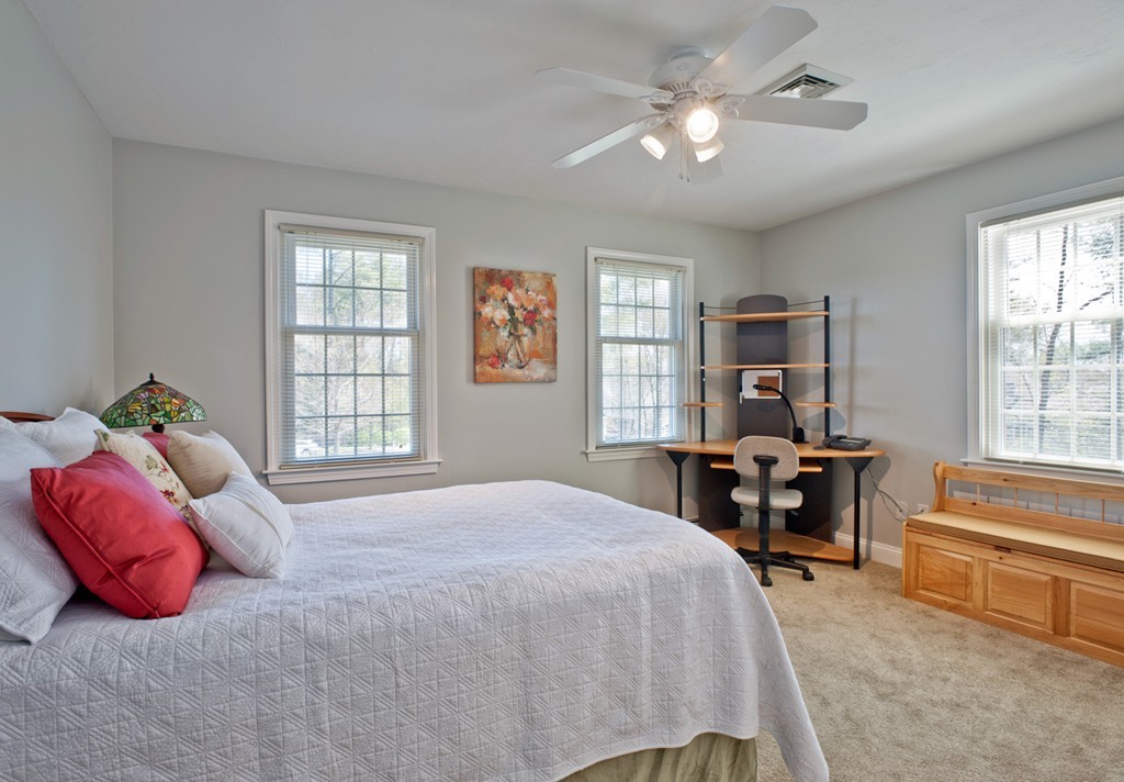 79 Linden Lane Hanover, MA 02339 - Photo 18 of 30 a bedroom with a bed and a chandelier