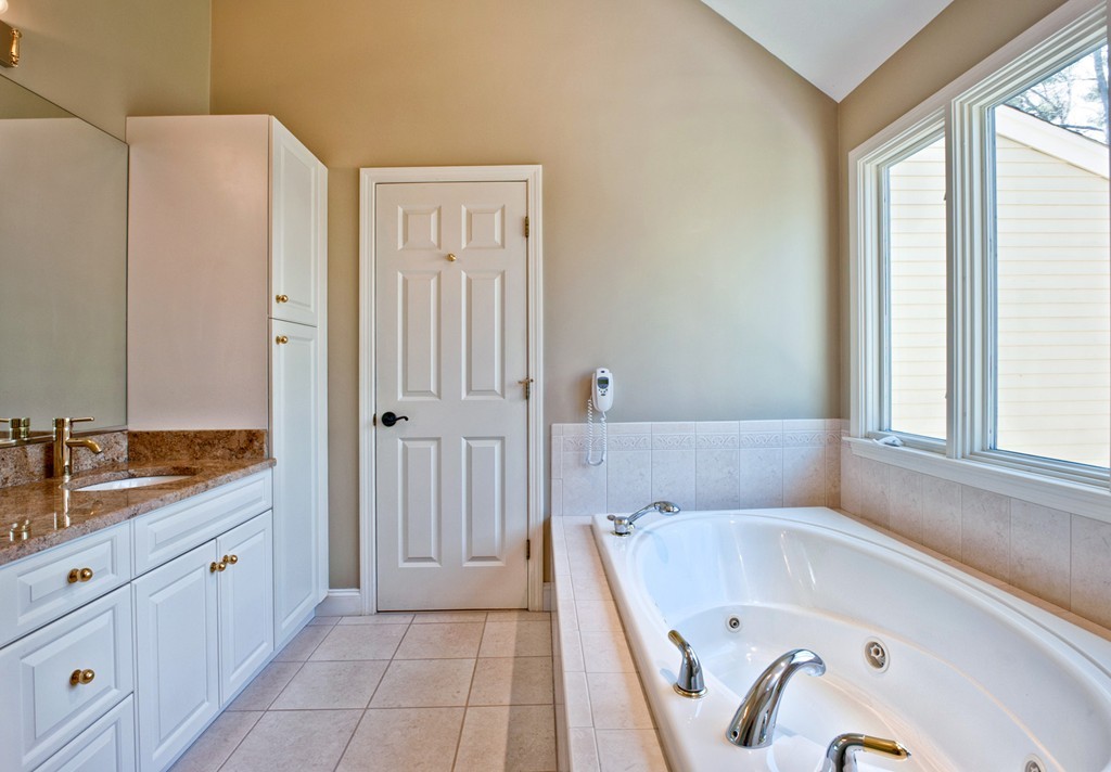 79 Linden Lane Hanover, MA 02339 - Photo 19 of 30 a bathroom with a tub sink and mirror