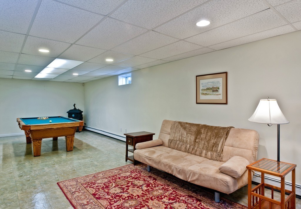 79 Linden Lane Hanover, MA 02339 - Photo 20 of 30 a living room with furniture and a rug