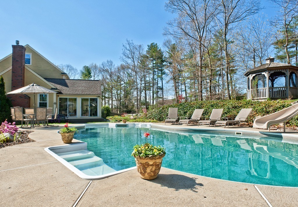 79 Linden Lane Hanover, MA 02339 - Photo 22 of 30 a view of a swimming pool with chairs and tables