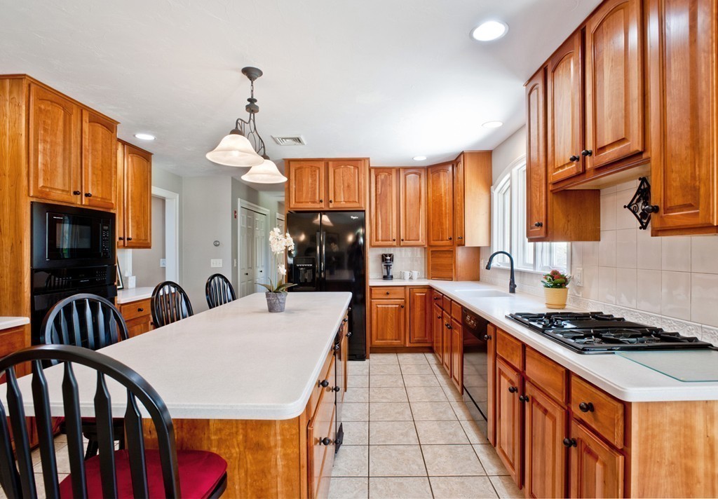 79 Linden Lane Hanover, MA 02339 - Photo 5 of 30 a kitchen with stainless steel appliances a sink a stove a refrigerator cabinets and a dining table