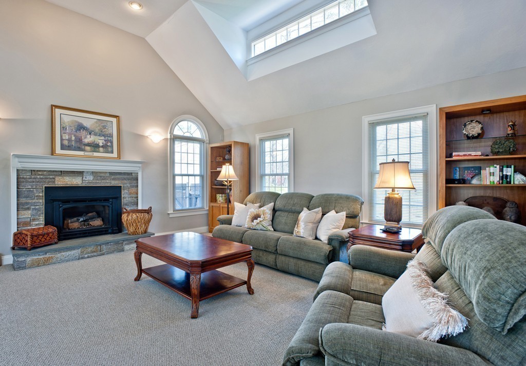 79 Linden Lane Hanover, MA 02339 - Photo 7 of 30 a living room with furniture and a fireplace