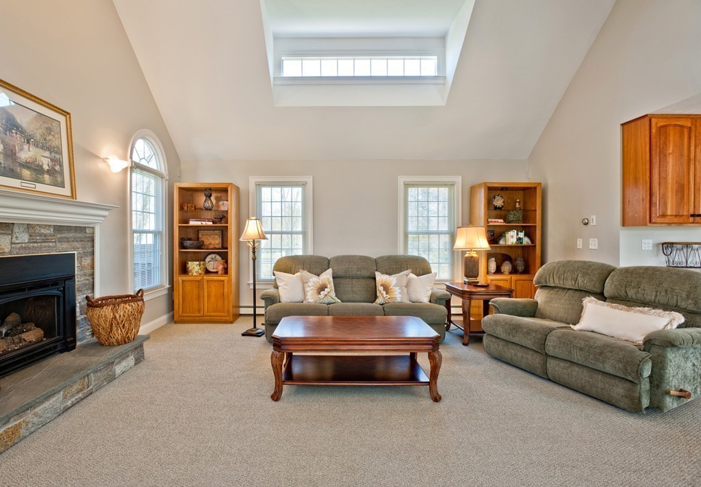 79 Linden Lane Hanover, MA 02339 - Photo 9 of 30 a living room with furniture and a fireplace
