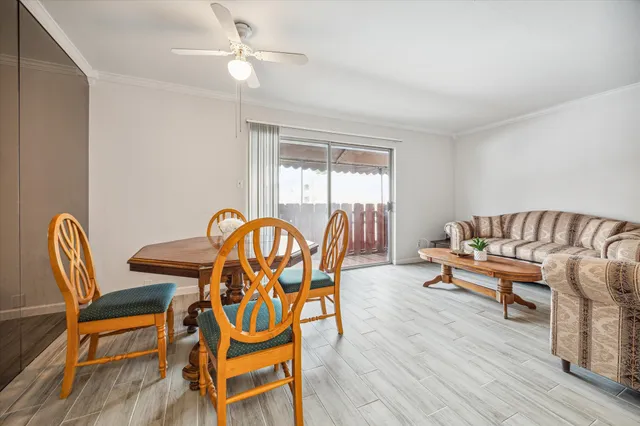 a view of a dining room with furniture wooden floor and chandelier