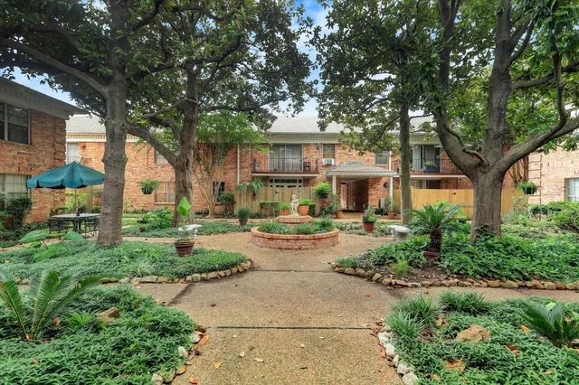 a view of house with backyard and sitting area