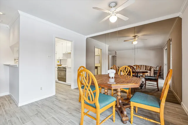 a dining room with furniture and wooden floor