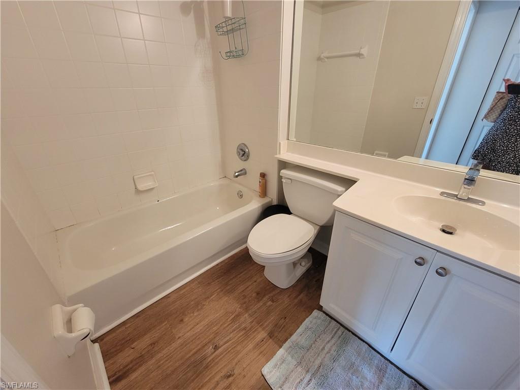 4950 Deerfield Way, Unit D202 Naples, FL 34110 - Photo 11 of 21 a bathroom with a sink a toilet and shower