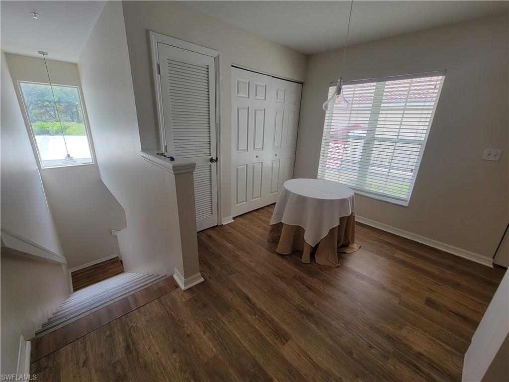4950 Deerfield Way, Unit D202 Naples, FL 34110 - Photo 14 of 21 a living room with a chair and a window