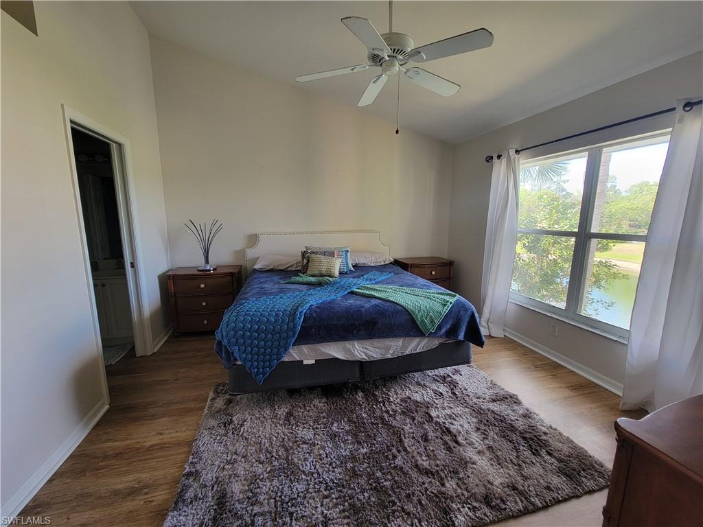 4950 Deerfield Way, Unit D202 Naples, FL 34110 - Photo 16 of 21 a bed sitting in a bedroom next to a window