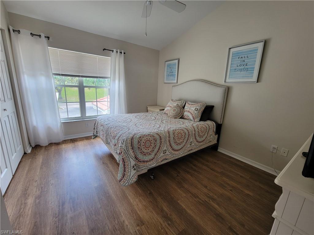 4950 Deerfield Way, Unit D202 Naples, FL 34110 - Photo 17 of 21 a bedroom with a bed and a window