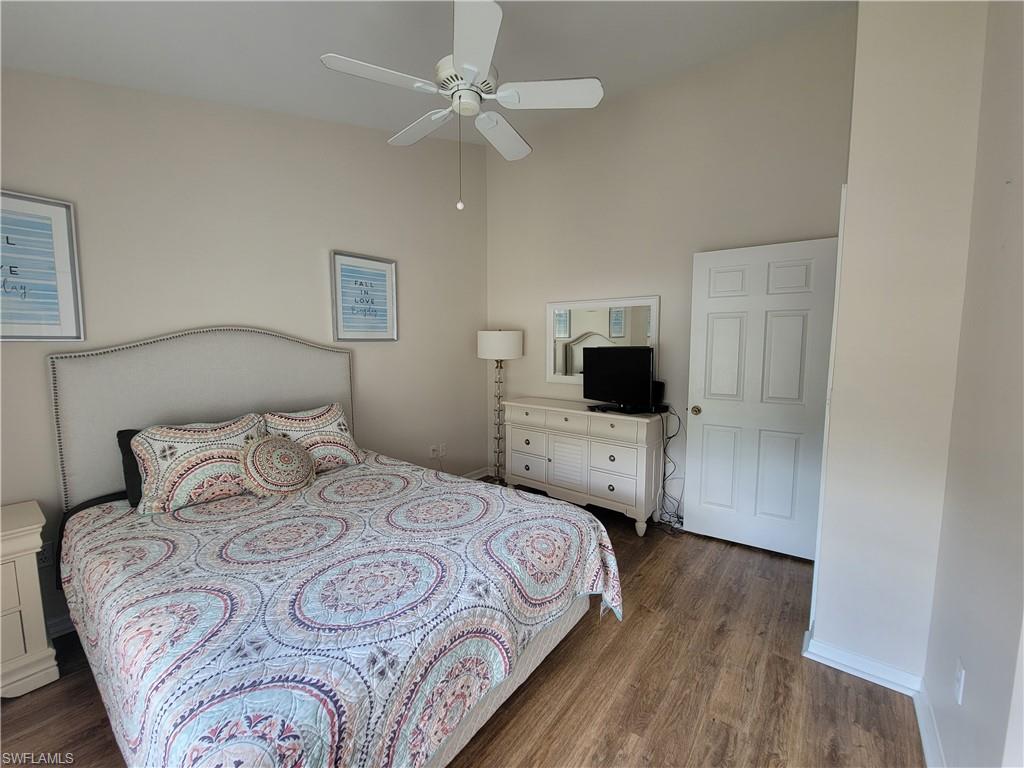 4950 Deerfield Way, Unit D202 Naples, FL 34110 - Photo 18 of 21 a bedroom with a bed and a flat screen tv