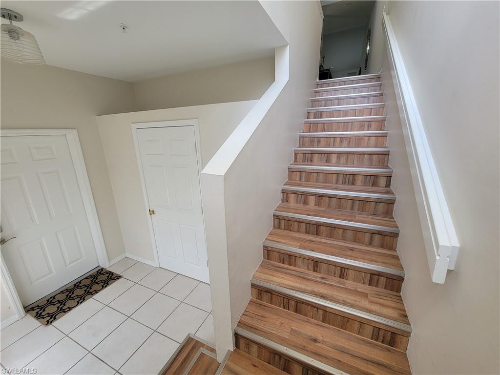 4950 Deerfield Way, Unit D202 Naples, FL 34110 - Photo 3 of 21 a view of staircase with white walls and a window