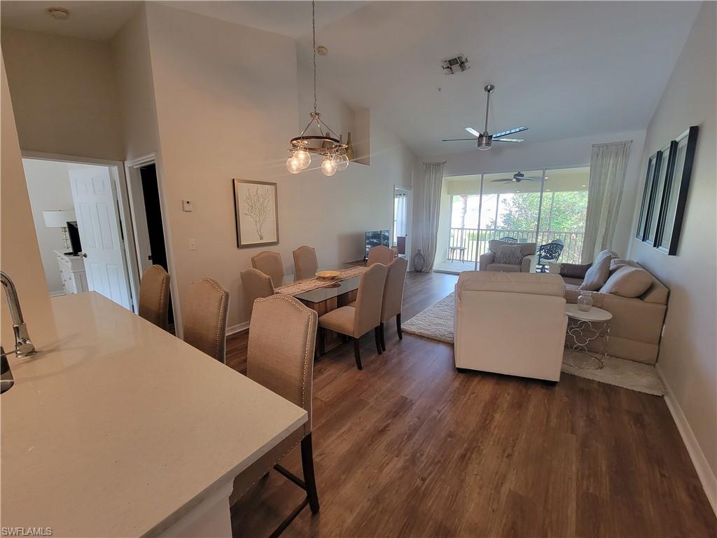 4950 Deerfield Way, Unit D202 Naples, FL 34110 - Photo 6 of 21 a living room with furniture and a chandelier