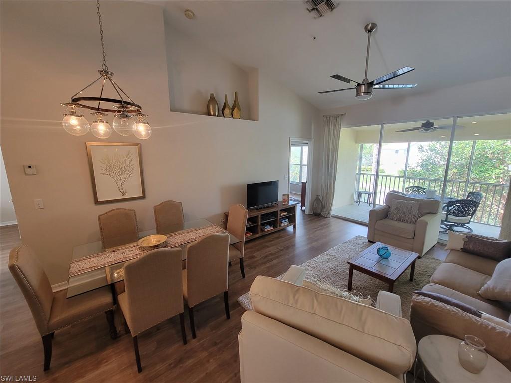 4950 Deerfield Way, Unit D202 Naples, FL 34110 - Photo 7 of 21 a living room with furniture and a flat screen tv