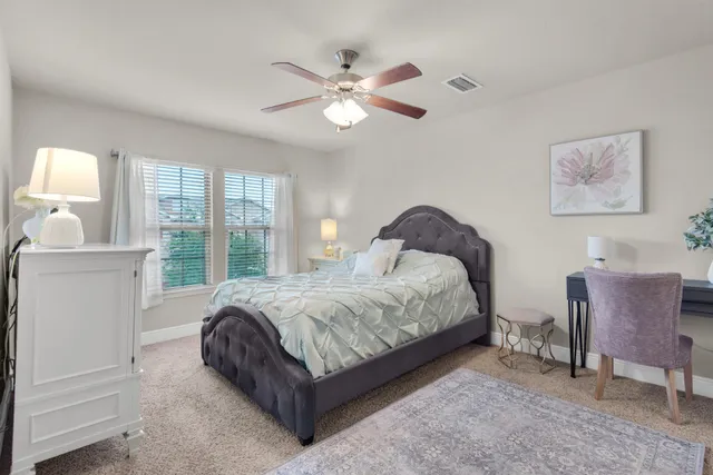 a spacious bedroom with a bed and window