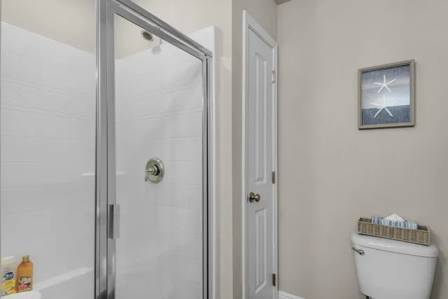 a bathroom with a toilet and a shower