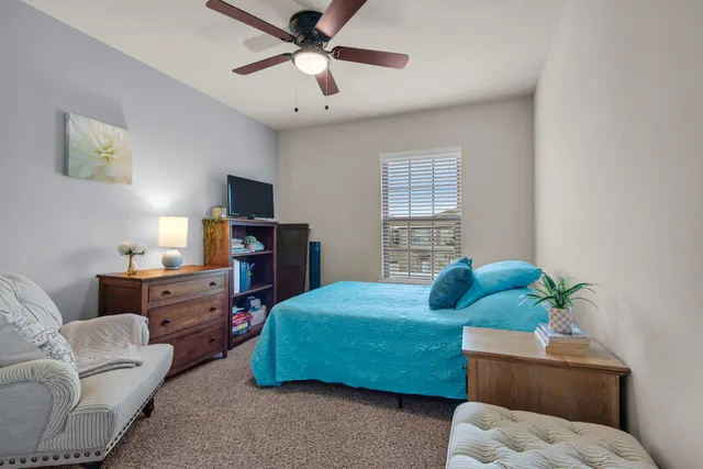 a bedroom with a bed and a couch