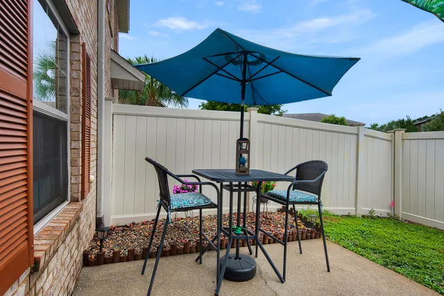 a patio with a table and chairs