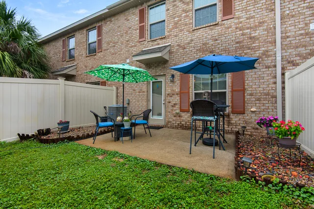 a view of a table and chairs under an umbrella in the patio