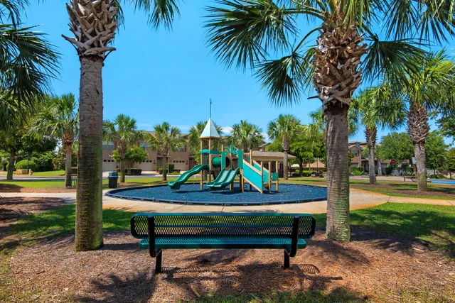a backyard of a house with table and chairs plants