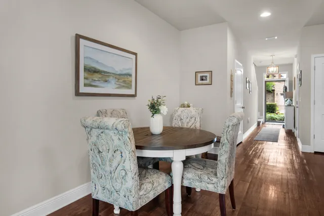a dining room with furniture and wooden floor