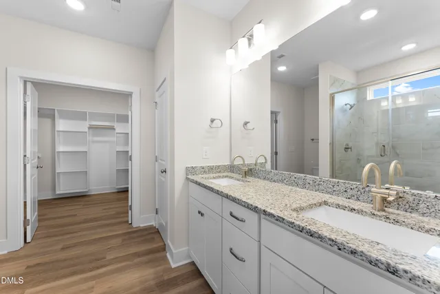 a bathroom with a granite countertop sink mirror and double