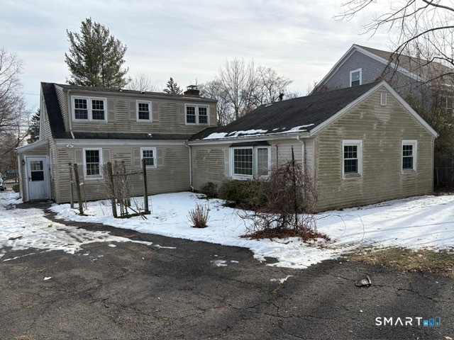 329 Bronson Road Fairfield, CT 06890 - Photo 8 of 23 a view of a house with snow on the road